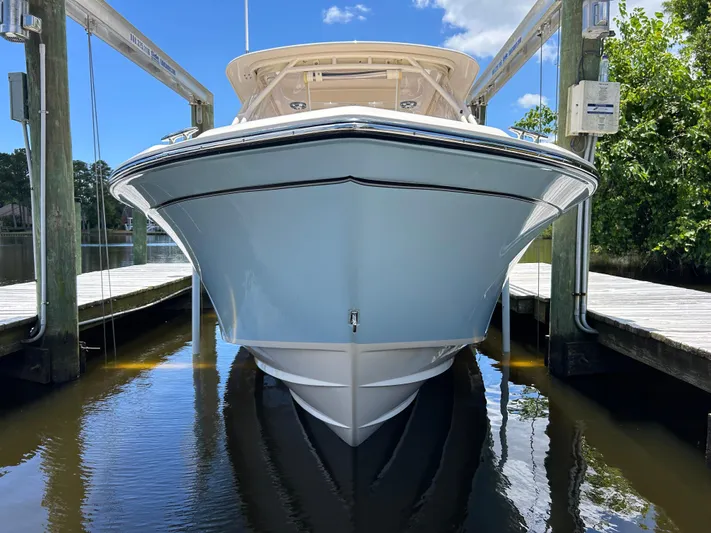  Yacht Photos Pics 2022 Grady-White 255 FREEDOM boat docked, front view, in a serene marina setting.