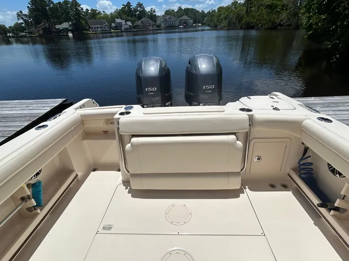  Yacht Photos Pics 2022 Grady-White 255 FREEDOM boat with dual engines on a serene lake.