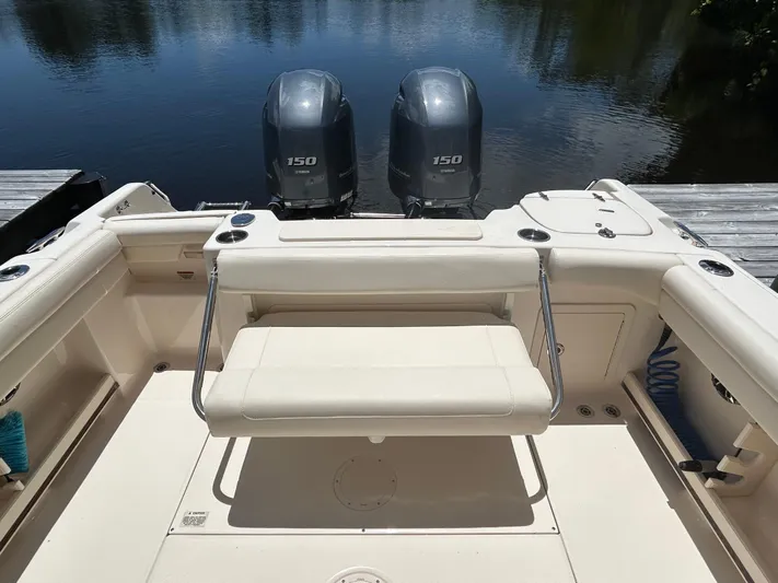  Yacht Photos Pics 2022 Grady-White 255 FREEDOM boat with dual 150 engines, docked by calm water.