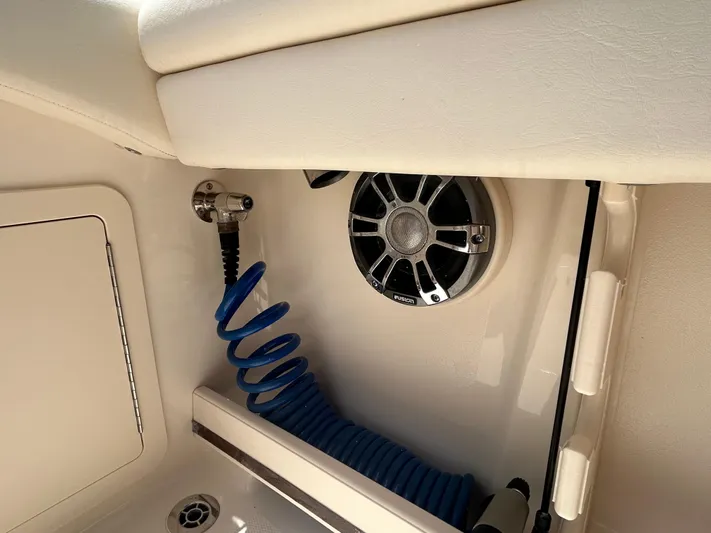  Yacht Photos Pics 2022 Grady-White 255 FREEDOM boat interior with speaker and coiled blue hose.