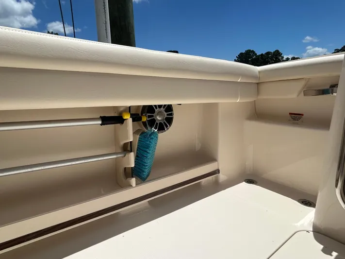  Yacht Photos Pics 2022 Grady-White 255 FREEDOM boat interior with storage compartment and cleaning brush.