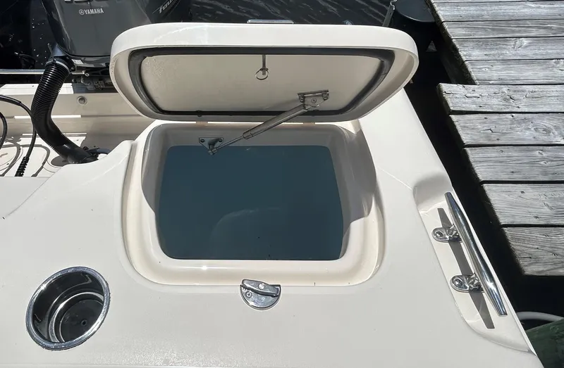  Yacht Photos Pics 2022 Grady-White 255 FREEDOM boat with open storage compartment near dock.