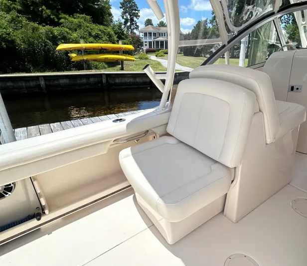  Yacht Photos Pics 2022 Grady-White 255 FREEDOM boat interior with white seating near dock.