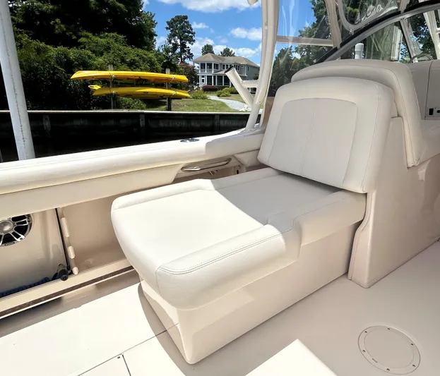  Yacht Photos Pics 2022 Grady-White 255 FREEDOM boat interior with white seating, docked near a house.