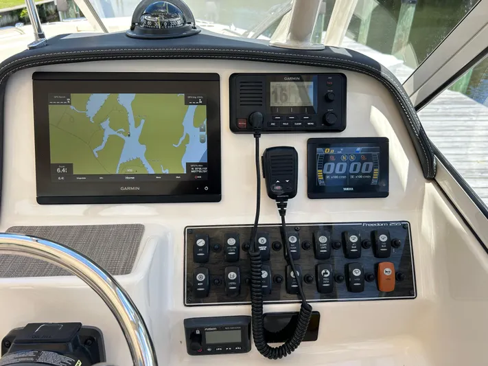  Yacht Photos Pics 2022 Grady-White 255 FREEDOM boat dashboard with navigation and control panels.