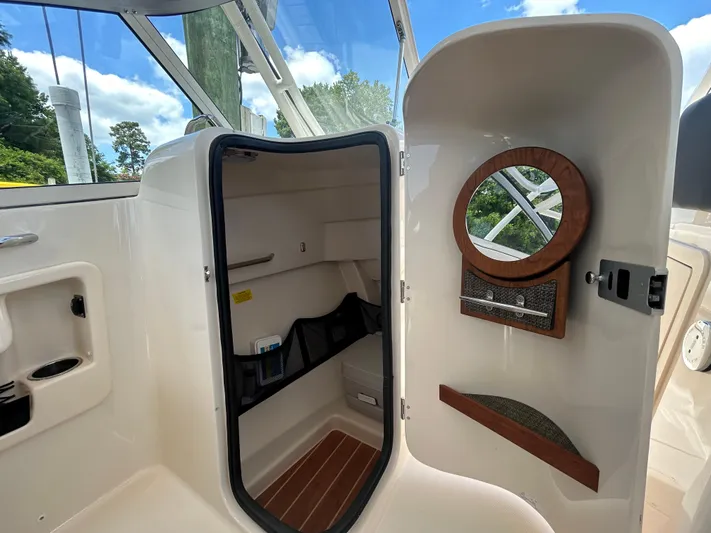  Yacht Photos Pics 2022 Grady-White 255 FREEDOM boat interior with storage and mirror.