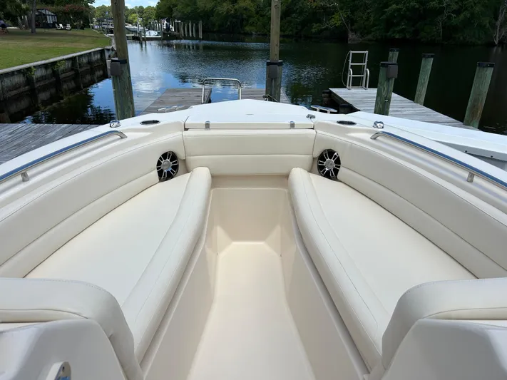  Yacht Photos Pics 2022 Grady-White 255 FREEDOM boat interior with white seating, docked by a serene waterway.