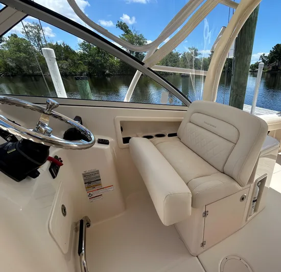  Yacht Photos Pics 2022 Grady-White 255 FREEDOM boat interior with steering wheel and cushioned seating.