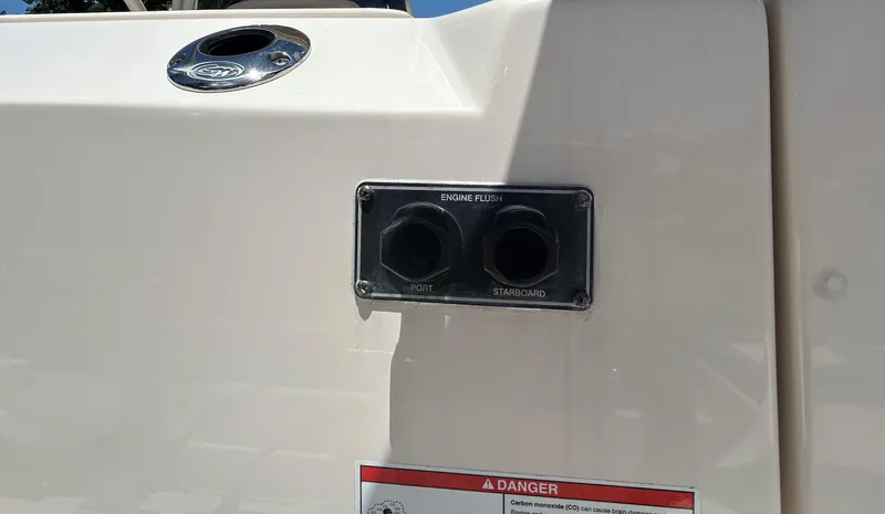  Yacht Photos Pics 2022 Grady-White 255 FREEDOM boat engine flush ports with warning label.