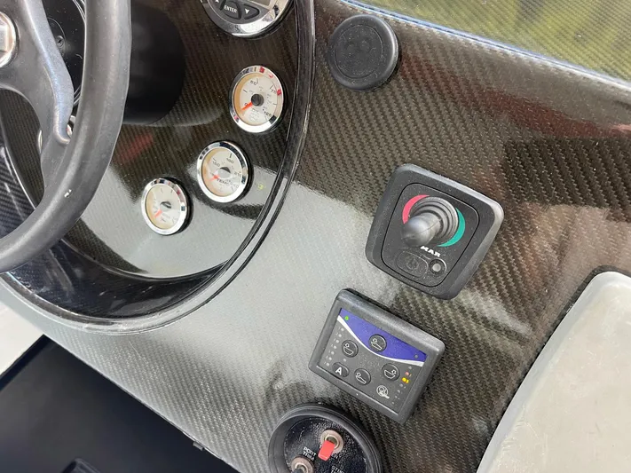  Yacht Photos Pics Carbon fiber dashboard of 2008 Goetz Custom Boats 33' Limo Tender with gauges and controls.