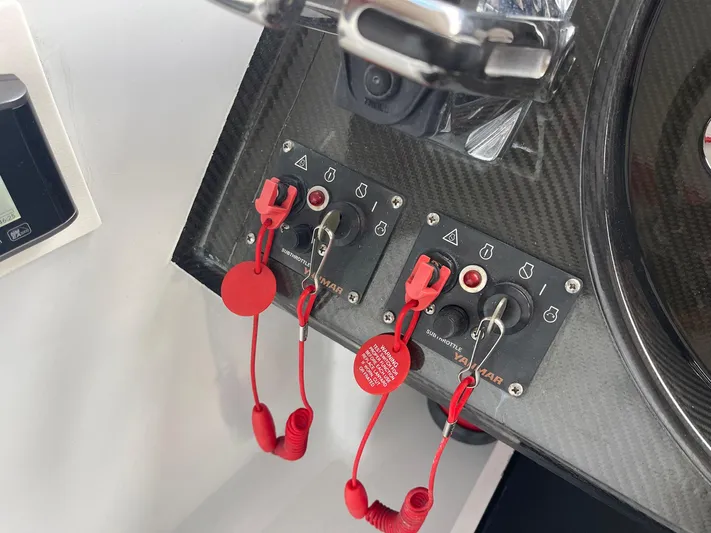  Yacht Photos Pics Control panel of a 2008 Goetz Custom Boats 33' Limo Tender with red safety lanyards.