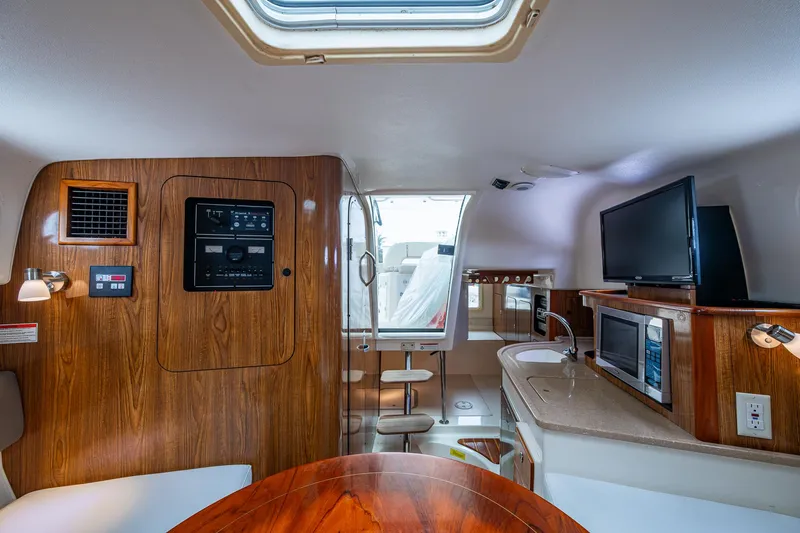  Yacht Photos Pics Interior of 2008 Pursuit OS 315 Offshore boat with wood paneling and modern amenities.