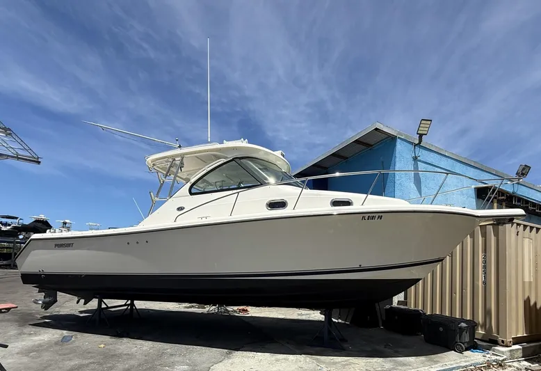  Yacht Photos Pics 2008 Pursuit OS 315 Offshore boat on dry dock under clear blue sky.