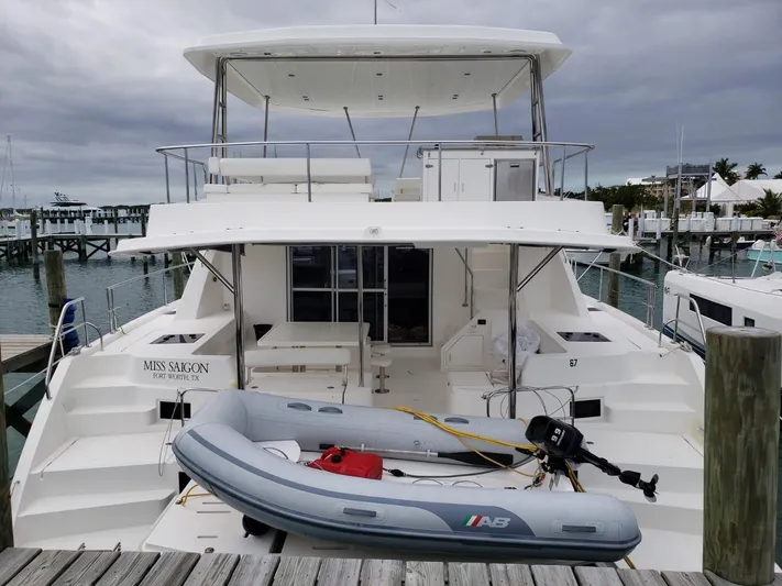 Miss Saigon Yacht Photos Pics 2019 Leopard 51 Powercat yacht docked with inflatable boat on deck.