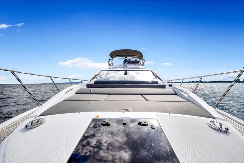 Amf Yacht Photos Pics Azimut S6 2021 yacht cruising on open water under a clear blue sky.