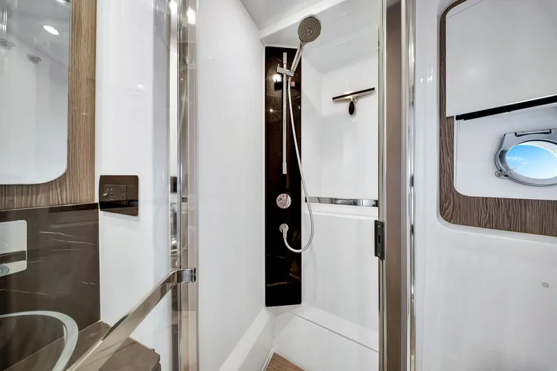 Amf Yacht Photos Pics Luxurious bathroom in 2021 Azimut S6 yacht with modern shower and porthole window.