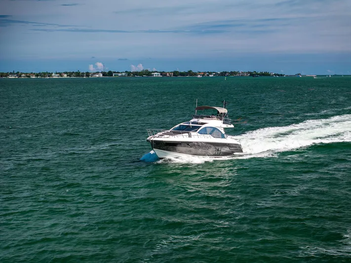 Amf Yacht Photos Pics 2021 Azimut S6 yacht cruising on open water with distant shoreline.