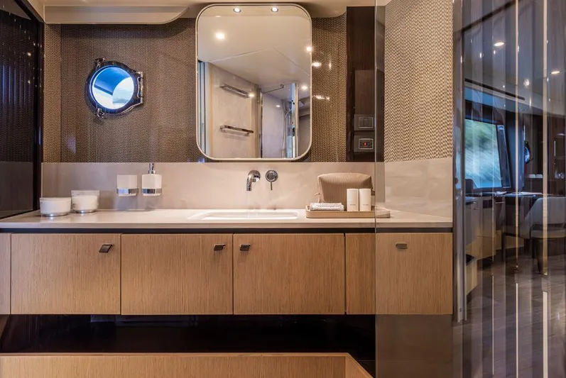 Absolute 56 Fly Yacht Photos Pics Luxurious bathroom interior of 2025 Absolute 56 FLY yacht with modern fixtures and porthole.
