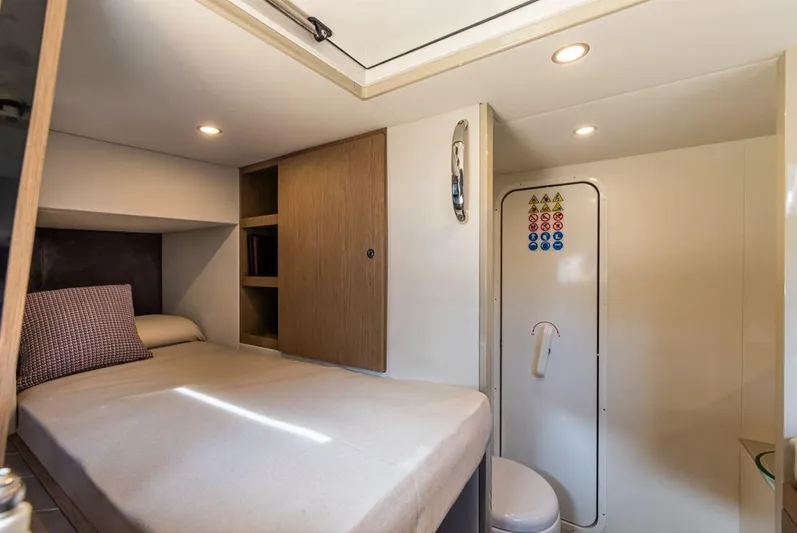 Absolute 56 Fly Yacht Photos Pics Cozy cabin interior of 2025 Absolute 56 FLY yacht with bed and storage.