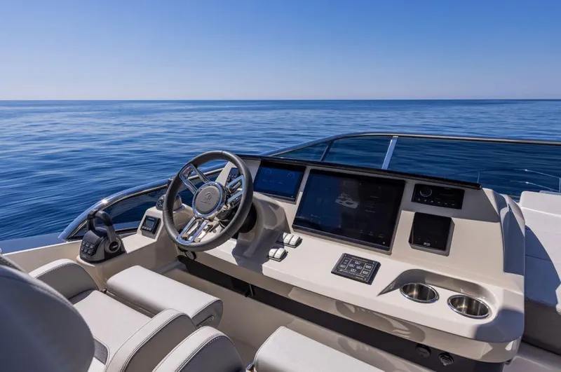 Absolute 56 Fly Yacht Photos Pics Helm of 2025 Absolute 56 FLY yacht with ocean view, featuring modern controls and navigation screens.