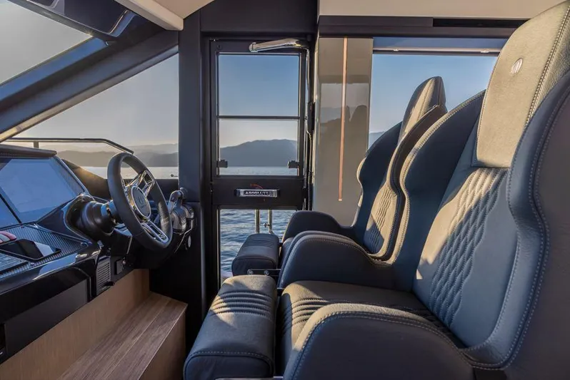Absolute 56 Fly Yacht Photos Pics Luxurious interior of 2025 Absolute 56 FLY yacht with plush seating and modern dashboard.