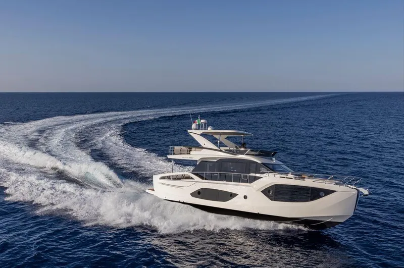 Absolute 56 Fly Yacht Photos Pics 2025 Absolute 56 FLY yacht cruising on open sea, creating a dynamic water trail.