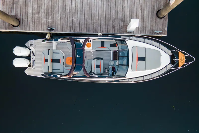 Custom Order Your 305 Today! Yacht Photos Pics Overhead view of 2026 Hanover 305 Outboard boat docked at a wooden pier.