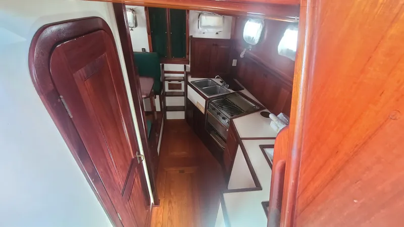 Chantey II Yacht Photos Pics 1989 Covey Island 48 Motorsailor interior with wooden cabinetry and compact kitchen area.