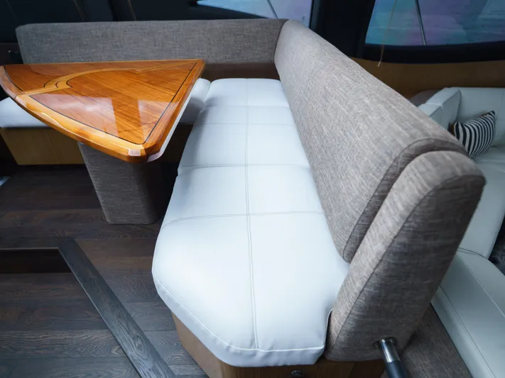 Lakehouse Yacht Photos Pics Luxurious seating area on 2016 Sea Ray L590 yacht with elegant wooden table.