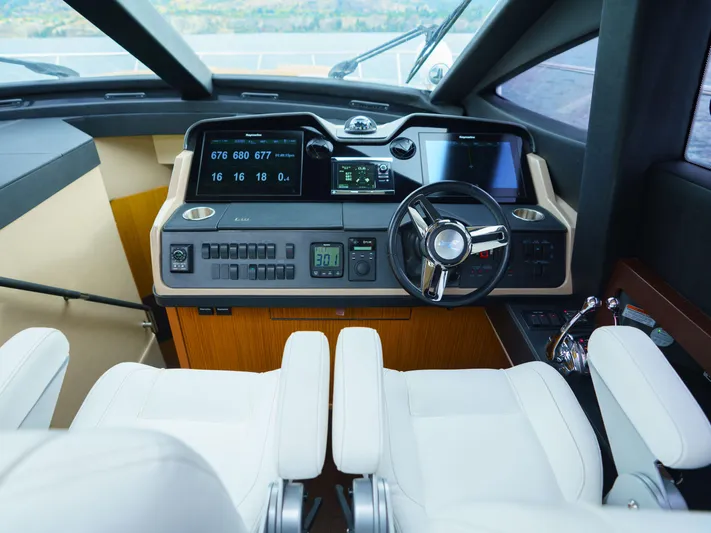 Lakehouse Yacht Photos Pics Luxurious helm of 2016 Sea Ray L590 yacht with modern controls and white seating.