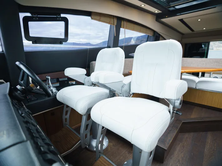 Lakehouse Yacht Photos Pics Interior of 2016 Sea Ray L590 yacht with white captain chairs and modern dashboard.