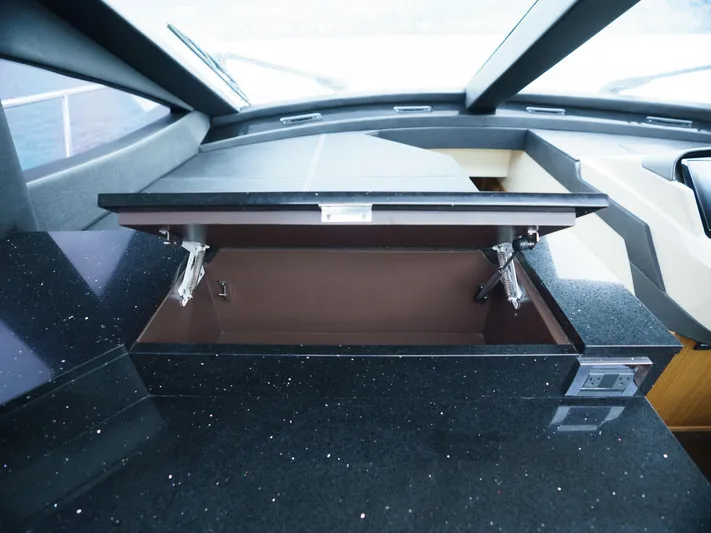 Lakehouse Yacht Photos Pics 2016 Sea Ray L590 yacht interior with open storage compartment and sleek black countertop.