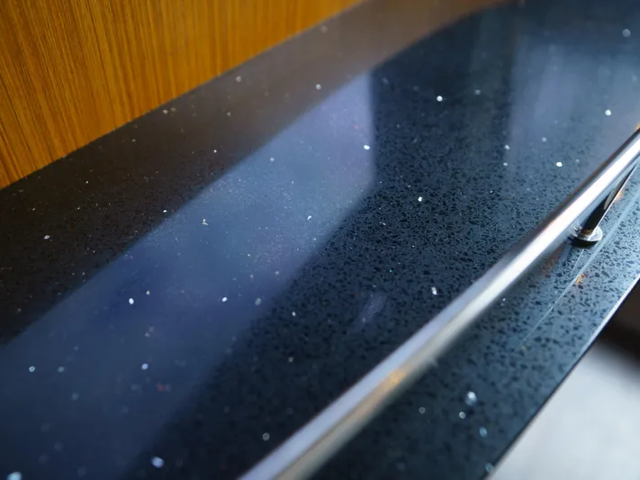 Lakehouse Yacht Photos Pics 2016 Sea Ray L590 yacht interior with sleek, speckled black countertop and wooden accents.