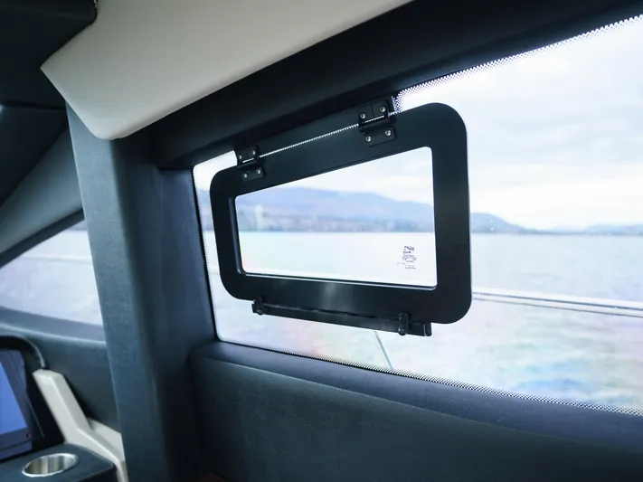 Lakehouse Yacht Photos Pics Window view from 2016 Sea Ray L590 yacht, overlooking serene water and distant hills.