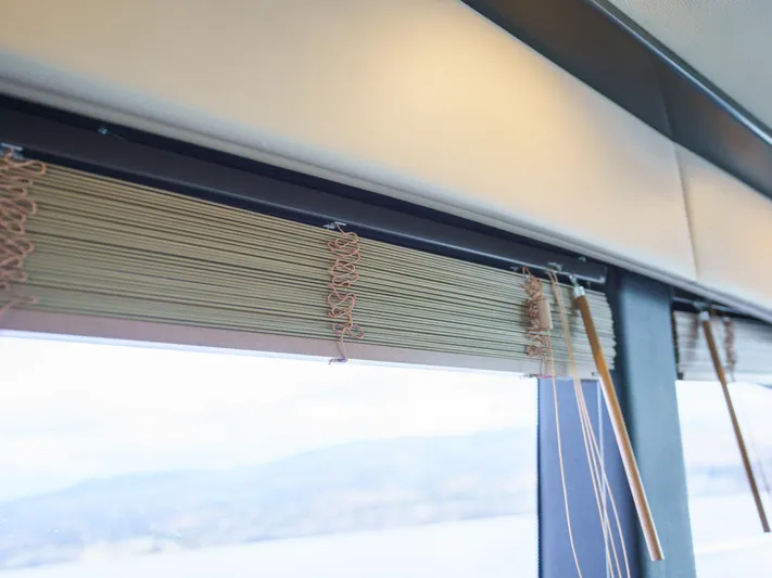 Lakehouse Yacht Photos Pics Window blinds inside a 2016 Sea Ray L590 yacht, showcasing elegant interior design.