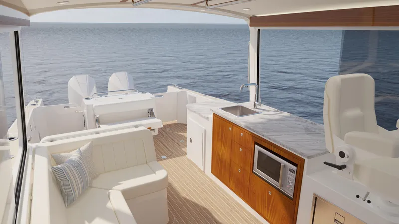  Yacht Photos Pics Luxurious interior of 2026 MJM 38R yacht with ocean view, featuring seating and kitchenette.