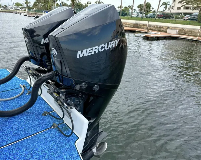  Yacht Photos Pics Twin Mercury outboard engines on a 1993 Crusader Boats 34, docked by the water.