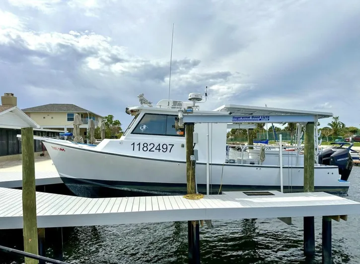  Yacht Photos Pics 1993 Crusader Boats 34 docked, showcasing sleek design and registration number 1182497.