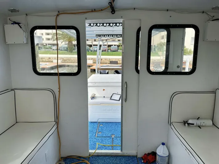  Yacht Photos Pics Interior view of a 1993 Crusader Boats 34, featuring seating and a doorway to the deck.