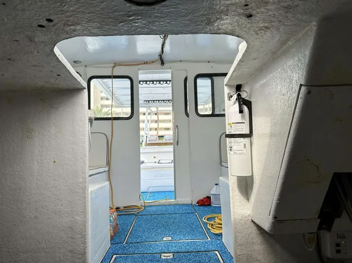  Yacht Photos Pics Interior view of a 1993 Crusader Boats 34, featuring blue carpet and open cabin doors.