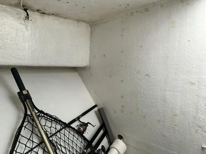  Yacht Photos Pics Storage area in a 1993 Crusader Boats 34, featuring fishing gear and a net.