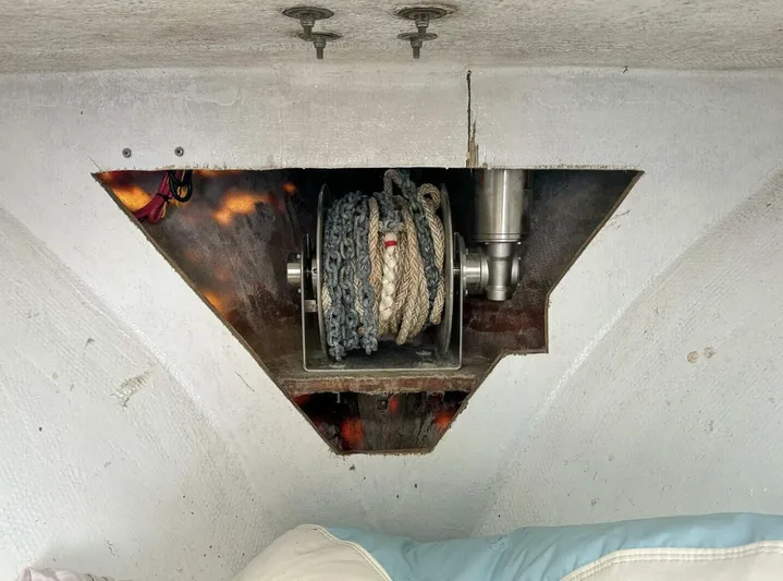  Yacht Photos Pics Anchor winch system inside 1993 Crusader Boats 34, featuring coiled rope and chain.