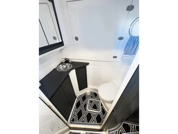  Yacht Photos Pics Modern 2018 Cigarette GTO boat bathroom with sleek design and geometric rug.