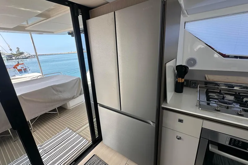 Hamlet Yacht Photos Pics Modern kitchen on 2023 Leopard 46PC yacht with stainless steel appliances and ocean view.