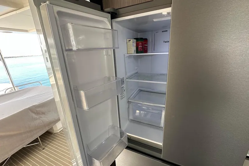 Hamlet Yacht Photos Pics Open refrigerator on Leopard 46PC yacht, showcasing spacious interior and ocean view.
