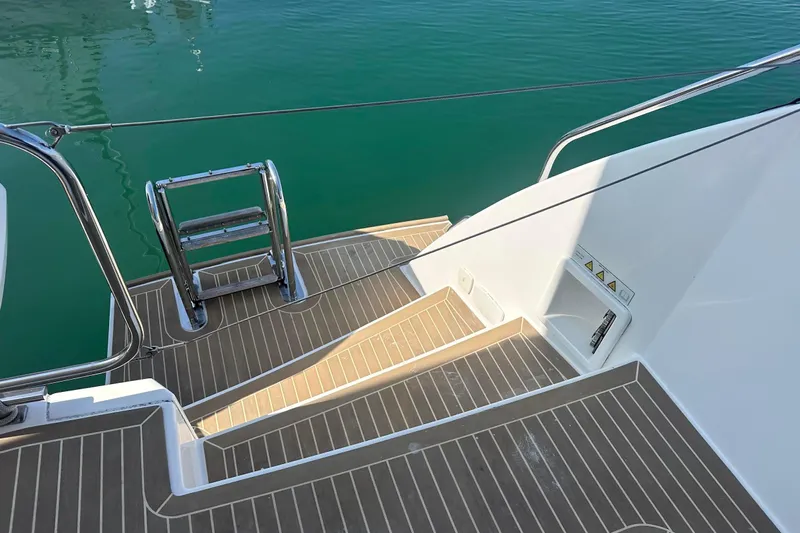 Hamlet Yacht Photos Pics Staircase and ladder on 2023 Leopard 46PC yacht, leading to turquoise water.