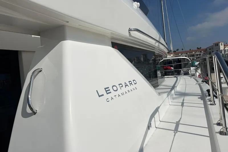 Hamlet Yacht Photos Pics 2023 Leopard 46PC catamaran docked, showcasing sleek design and branding.