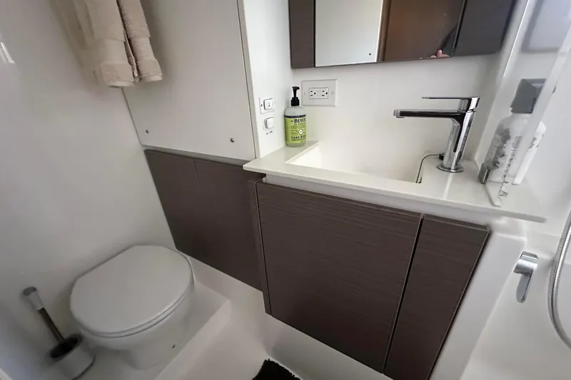 Hamlet Yacht Photos Pics Modern bathroom in 2023 Leopard 46PC yacht with sleek sink and toilet.