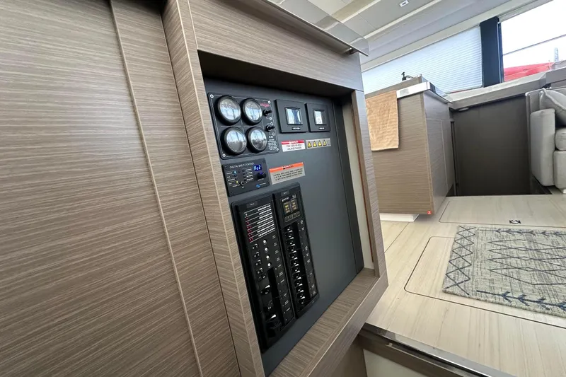 Hamlet Yacht Photos Pics Control panel inside 2023 Leopard 46PC yacht, featuring modern wood interior design.