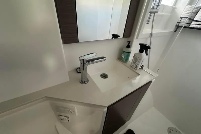 Hamlet Yacht Photos Pics Modern bathroom sink in 2023 Leopard 46PC yacht, featuring sleek faucet and toiletries.